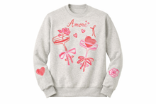 Load image into Gallery viewer, Amore Valentine crewneck sweatshirt in oatmeal heather with pink watercolor hearts, bows, and floral design, designed by Meg and pressed in-house at Reverie in Fayetteville North Carolina