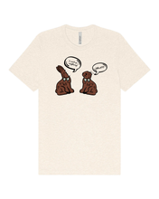 Load image into Gallery viewer, Heather natural women’s t-shirt featuring humorous chocolate bunny characters with bites taken out and speech bubbles
