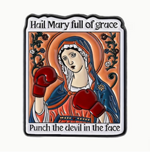 Load image into Gallery viewer, Funny Catholic-inspired enamel pin featuring a Mary-style devotional figure wearing red boxing gloves with text that reads “Hail Mary full of grace” and “Punch the devil in the face.”
