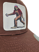 Load image into Gallery viewer, Sasquatch Trucker Mesh Snapback Hat: Brown on Khaki.
