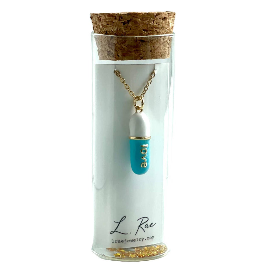 Love Pill. Gold Layer Charm Necklace. Glass vial display.